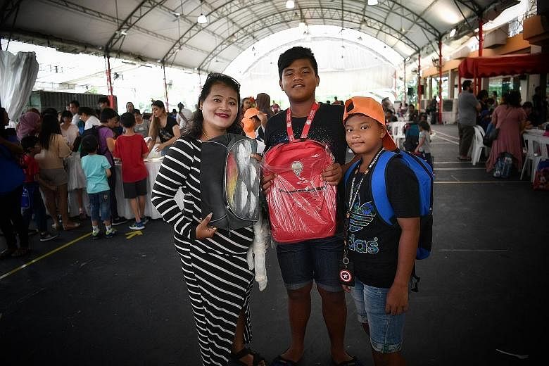 Madam Animaton Mohd Tahil and two of her sons, Mohammad Danial, 13, and Mohammad Diniy, 11. The boys were among 166 students who received support under the Pack My Backpack initiative.