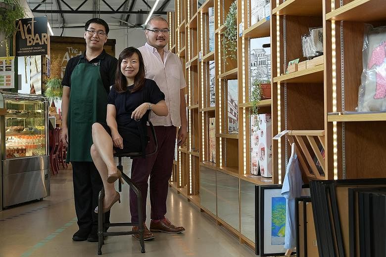Ms Jacelyn Lim, ARC's deputy executive director, flanked by Mr Caleb Lim (in apron) and Mr Victor Ong, the centre's creative director, at the Art Faculty's flagship store in Lengkok Bahru.