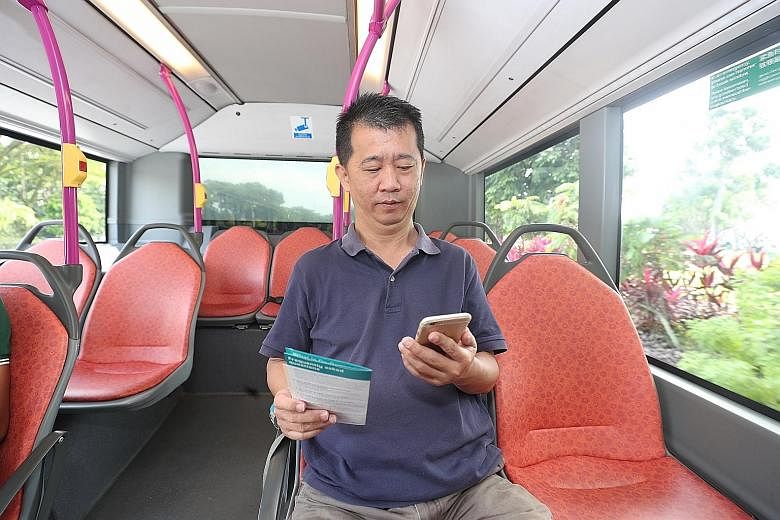 Journalist Zhaki Abdullah (left) booked an on-demand public bus in the Marina Bay area using the BusNow app yesterday, while Mr Low Chong Gee (below), 50, a shipping agent, tried out the same app.
