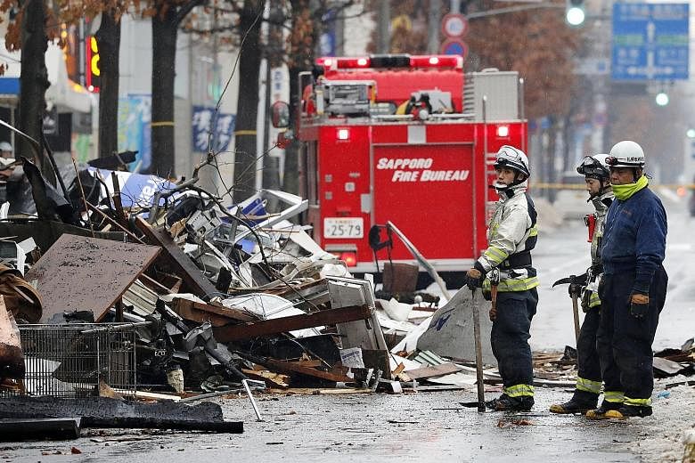 Firefighters at the site of the explosion in Sapporo, which also caused a temporary blackout at 250 buildings in the area.