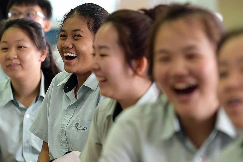 Hillgrove Secondary School student Nur Syafiqah Dahlan (second from left) and her schoolmates reacting to news of their school's performance in the N-level exams yesterday. She qualifies for Sec 5 and for Higher Nitec courses at the ITE. Principal An