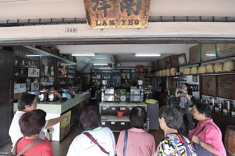 Participants taking in the strong aroma of freshly baked bread at Sweetlands Confectionery and Bakery yesterday in Kim Keat Lane, where they learn the process of making bread the old-fashioned way. The stretch of Sim Kwong Ho shophouses in Balestier 