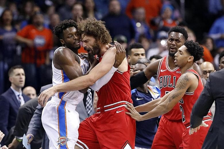 Oklahoma City Thunder forward Jerami Grant (far left) getting into a tussle with Robin Lopez of the Chicago Bulls during the National Basketball Association game at Chesapeake Energy Arena on Monday night. The Thunder won 121-96 and climbed to third 