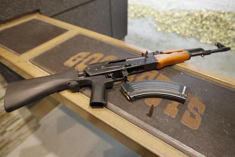 An AK-47 with a bump stock installed. The device harnesses the recoil of a semi-automatic rifle's discharge to make the trigger fire faster, effectively turning it into a fully automatic weapon.