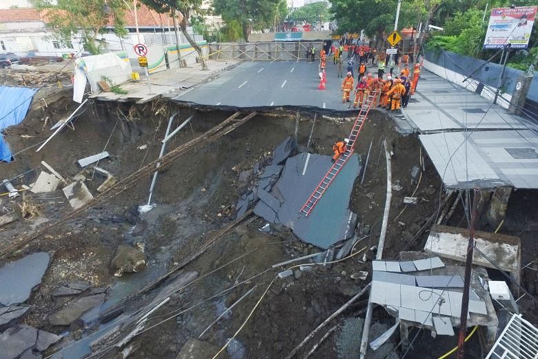 A 30m wide and 15m deep sinkhole appeared in the middle of a busy road in the city of Surabaya in East Java province on Tuesday evening, swallowing part of the four-lane Jalan Raya Gubeng. The Indonesian authorities say there were no reports of injur