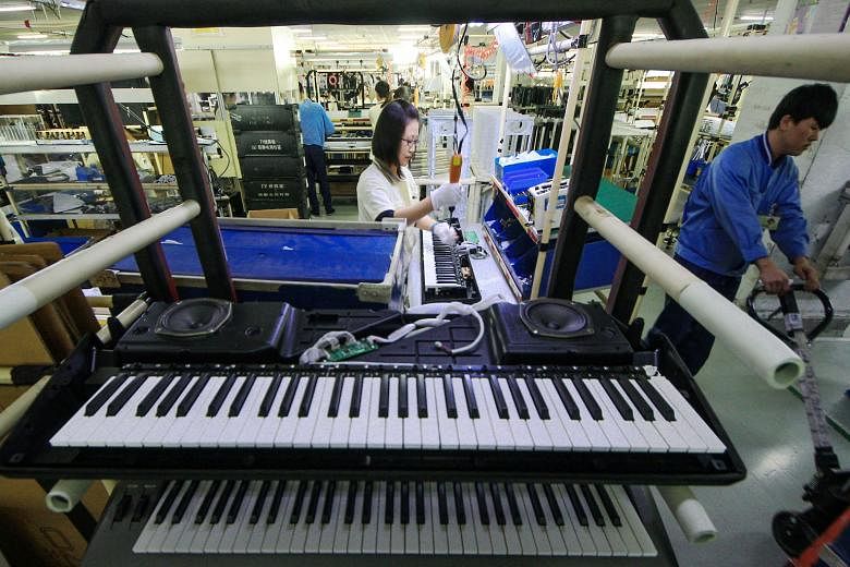 Chinese workers manufacturing electronic keyboards at a factory in Tianjin. China's large population and rapid wage growth have been significantly influencing the global average.