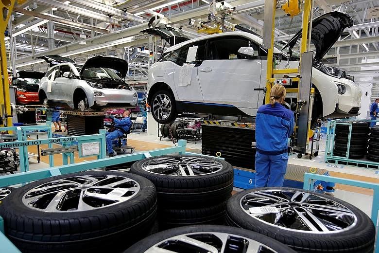 A BMW factory in Leipzig, Germany, in 2013. Carmakers are joining forces to cut costs and be more agile in the race to dominate digital services such as ride-hailing.