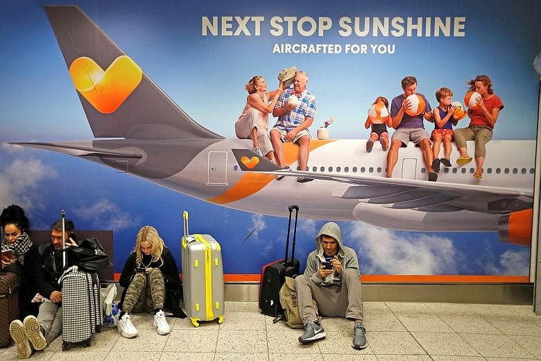 Stranded passengers waiting in the South Terminal building at Gatwick Airport yesterday. Flights were halted at Gatwick at 2103 GMT on Wednesday (5.03am in Singapore yesterday) after two drones were spotted flying near its airfield. Police said more 