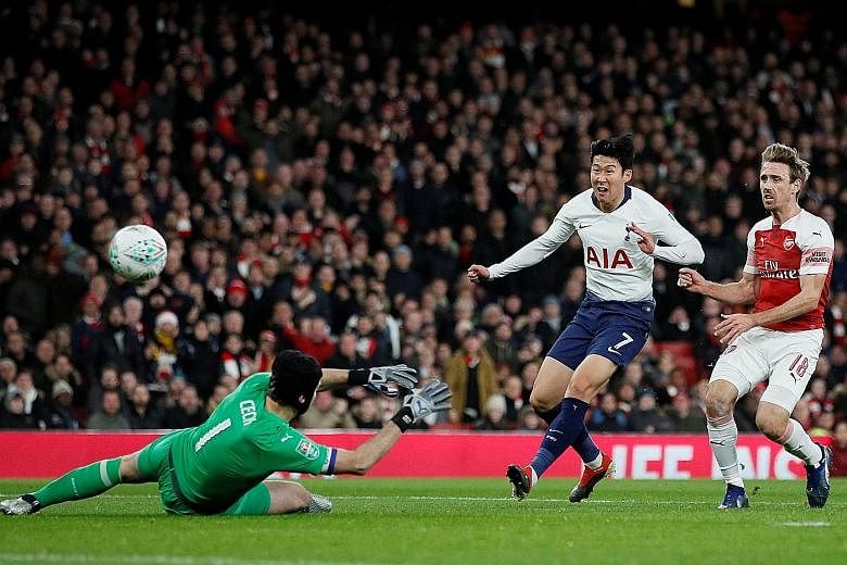 Above: Son Heung-min scoring past Arsenal goalkeeper Petr Cech to put Tottenham in the lead in their League Cup quarter-final at the Emirates Stadium. Left and below: Spurs' Dele Alli being led away by the Gunners' Sokratis Papastathopoulos after bei