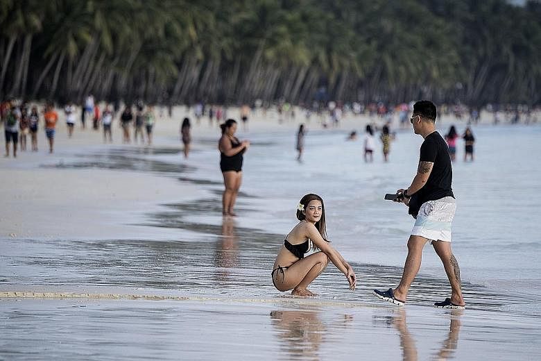 The Philippine government plans to clean up Manila Bay using the same methods it used for resort island Boracay (above) this year.