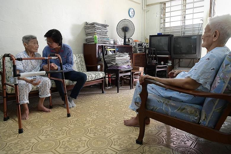 Postman Seah Seow Peng looks in on sisters Thi Lai Lee (left) and Teh Lai Wam at least once a week. Both elderly women have dementia.