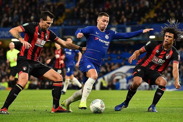 Chelsea midfielder Eden Hazard taking on Bournemouth defender Nathan Ake (right) and midfielder Charlie Daniels in their English League Cup quarter-final on Wednesday. The Belgian netted the only goal of the encounter at Stamford Bridge.