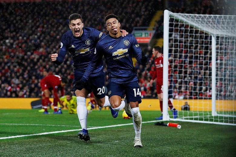 Manchester United's Jesse Lingard celebrating with Diogo Dalot after scoring in the 3-1 loss to Liverpool on Sunday. New Red Devils caretaker manager Ole Gunnar Solskjaer has been quick to preach an attacking mantra.