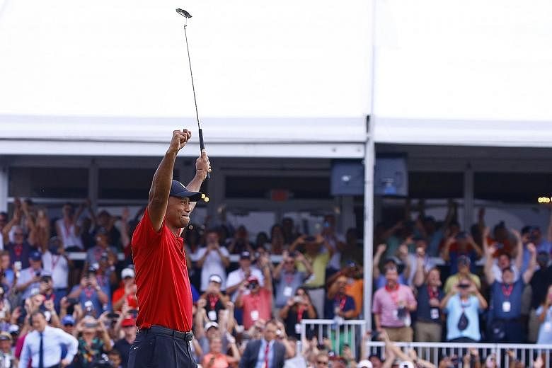 Former world No. 1 Tiger Woods raises his arms in triumph after winning the Tour Championship in September - his first PGA Tour victory in 1,876 days.