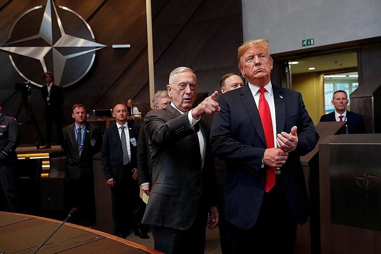 US President Donald Trump and Defence Secretary James Mattis arriving at the North Atlantic Council meeting in Brussels in July. Mr Mattis resigned a day after Mr Trump on Wednesday blindsided his national security establishment by announcing the wit