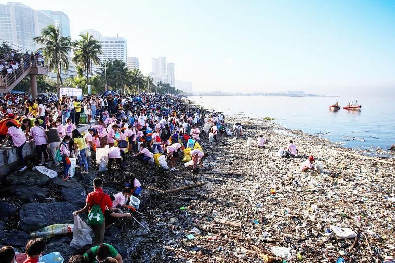 Volunteers picking up garbage at Manila Bay in September. A week-long clean-up yielded more than 54,200 pieces of plastic waste, as well as nappies, sanitary napkins and glass.