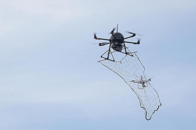 The jammer gun, which emits signals that can jam the control signals of drones, and the drone catcher system, which uses a net to catch drones, are among the Republic of Singapore Air Force's weapons that can be used against errant drones.