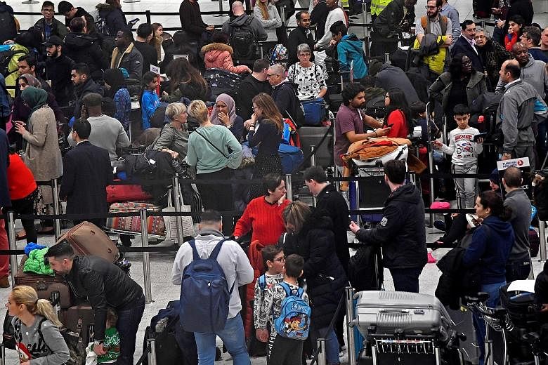 Passengers waiting to check in for their flights at Gatwick Airport last Friday, after the airport reopened, following its forced closure because of drone activity.