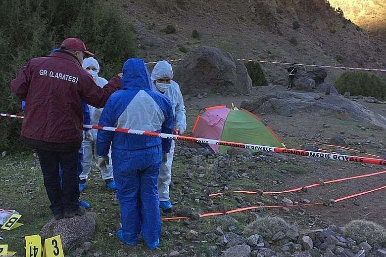 Ms Maren Ueland from Norway (far left) and Ms Louisa Vesterager Jespersen from Denmark were trekking in Morocco when they were murdered. Investigators (below) near the tent where the bodies of the women were found last Monday. Moroccan investigators 