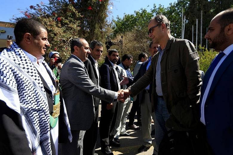 Retired Dutch general Patrick Cammaert (in sunglasses), who heads a UN team monitoring a ceasefire in Yemen's Hodeida, greeting officials upon his arrival in the Yemeni capital Sanaa yesterday.
