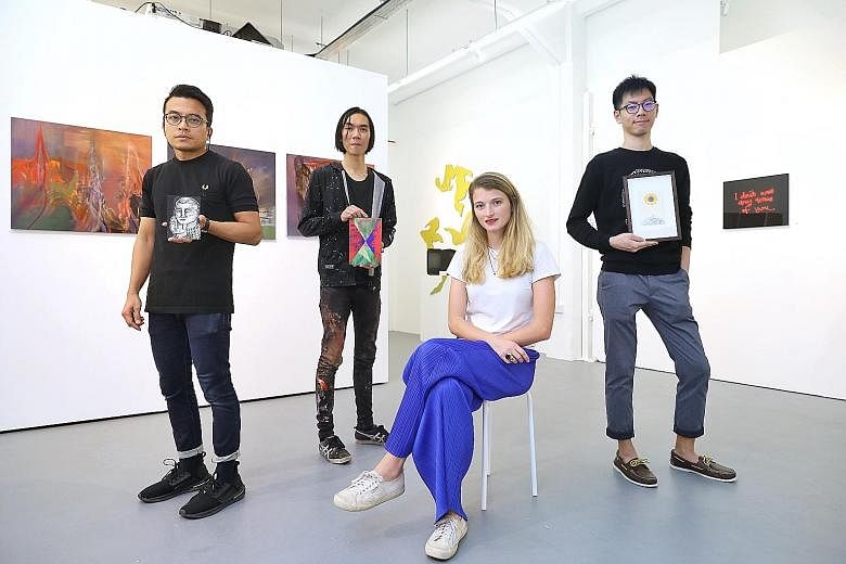Artists (from far left) Farizwan Fajari, Ruben Pang and Loi Cai Xiang were among those involved in the advent calendar sale, led by Chan + Hori Contemporary director Lisa Polten (seated).
