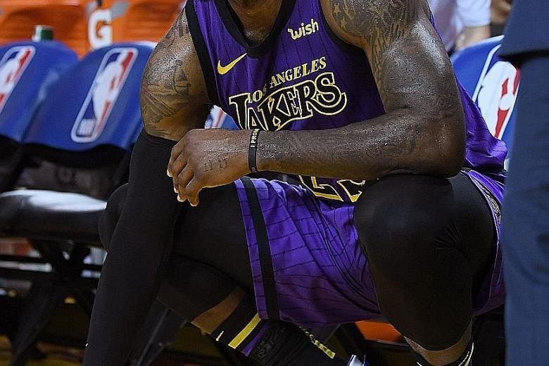 Left: Los Angeles Lakers star LeBron James grimacing in pain on the bench after he injured his groin against the Golden State Warriors during the second half of the Lakers' 127-101 upset win on Tuesday. The victory snapped an 11-game losing streak on
