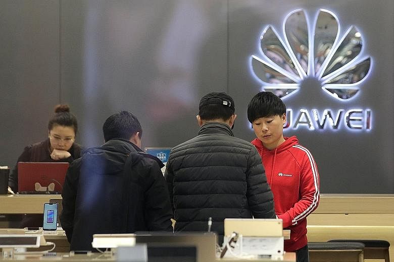 A Huawei store in Beijing. The company would report sales revenue of US$108.5 billion (S$149 billion), up 21 per cent year on year, rotating chairman Guo Ping said in a New Year message to staff. He also said the firm had signed 26 commercial deals f