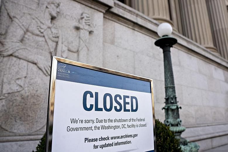 A sign announcing the closure of the National Archives due to the partial government shutdown is displayed in Washington on Thursday. The shutdown is expected to last into next weekend as a House session late on Thursday lasted mere minutes, failing 