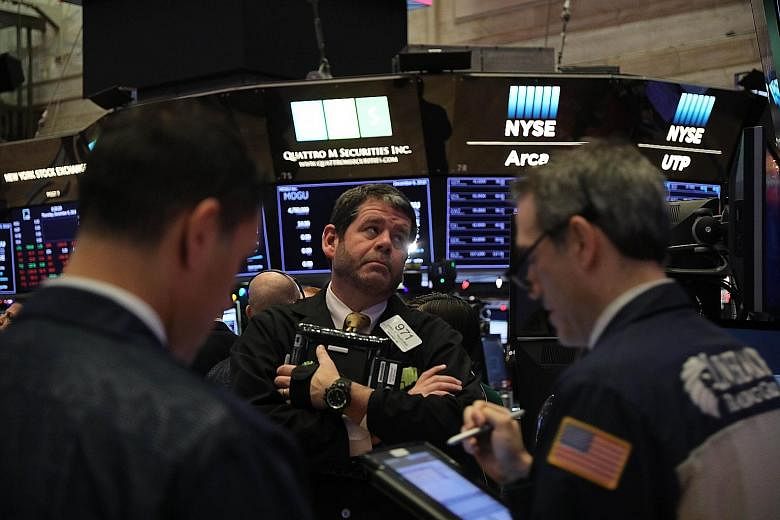 Traders on the floor of the New York Stock Exchange on Dec 6 when the Dow Jones Industrial Average fell over 400 points in morning trading. Escalating US-China trade tensions sent waves of volatility throughout the markets in the second half of this year,