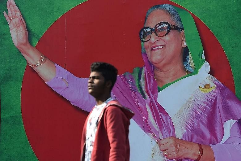 A campaign poster featuring Bangladeshi Prime Minister Sheikh Hasina, who is seeking a record fourth term in today's polls.