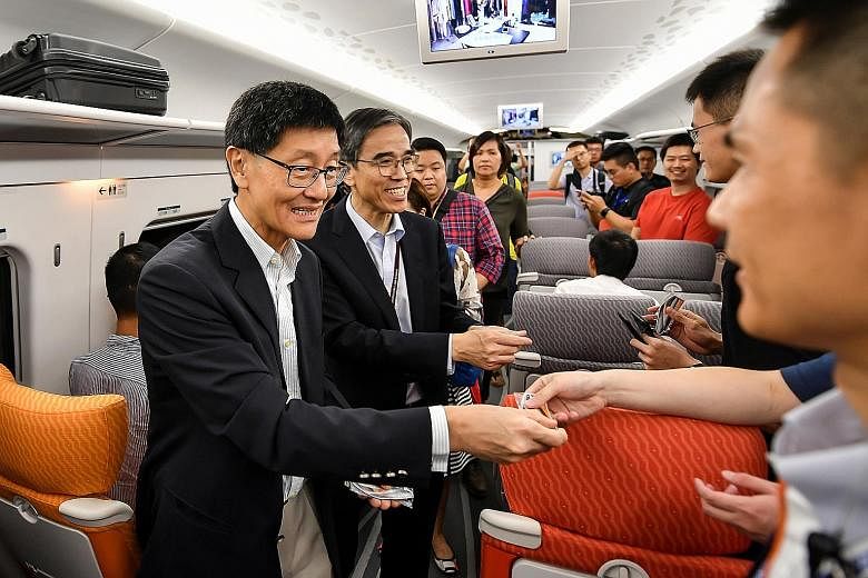 Above: Commuters at Wan Chai station of MTR's Island Line. Hong Kong's Mass Transit Railway has made enviable profits and is known for its largely sterling service record. Below: MTR Corp chief executive Lincoln Leong greeting passengers on a High-Sp
