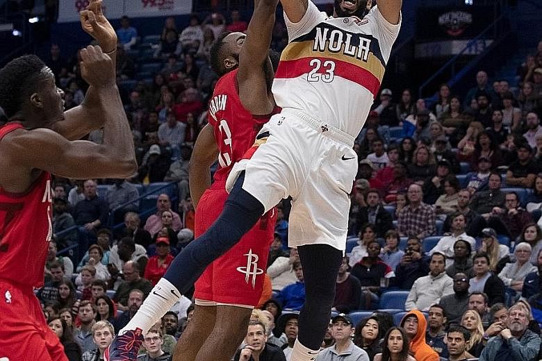 Rockets guard James Harden (left) trying to deter Pelicans forward Anthony Davis in Houston's 108-104 victory over New Orleans on Saturday. But it was Harden's work on the offensive end that won the day, as the reigning Most Valuable Player scored 41