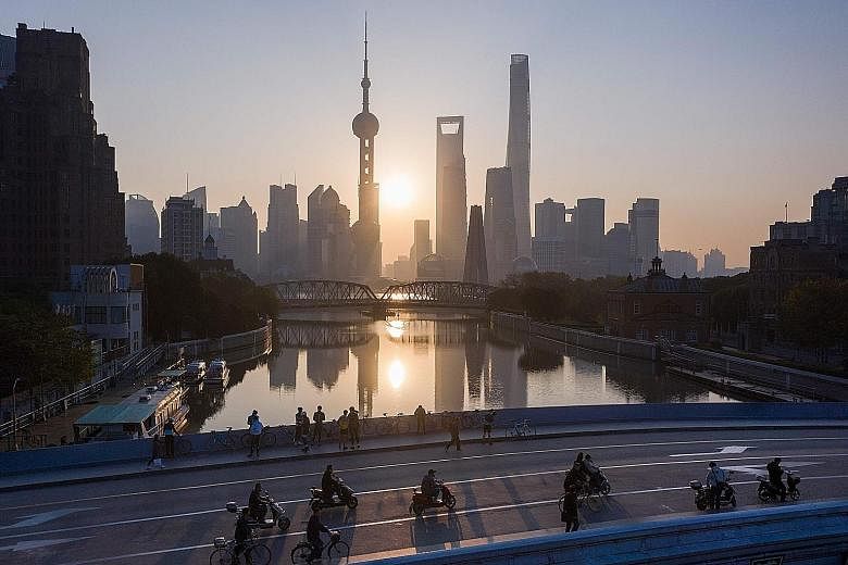Shanghai's Lujiazui Financial District of Pudong. Under new rules, lenders, including rural cooperatives and policy banks, will need to apply for a licence to operate units outside their home base or will have to wind down the businesses.