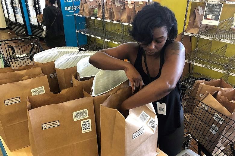 An employee packing a Whole Foods delivery order at a store in Cincinnati. Amazon.com is reportedly expanding the reach of its two-hour delivery service to nearly all of its roughly 475 stores in the United States, as well as other places where it cu