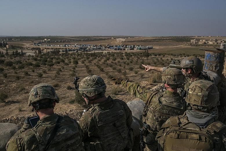 US Special Forces soldiers at a front line outpost outside Manbij, Syria, last February. The Pentagon says it is considering plans for a "deliberate and controlled withdrawal" from Syria.