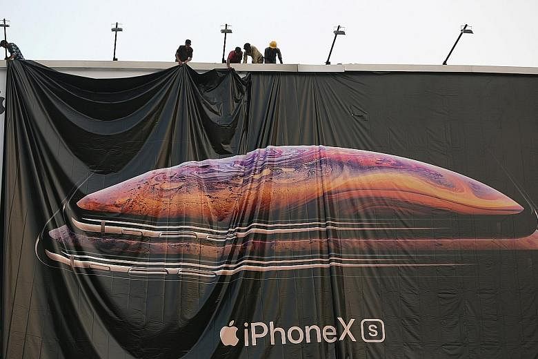 Workers adjusting the iPhone XS advertisement in India. Taiwanese contract manufacturer Foxconn will be assembling the most expensive models, such as devices in the iPhone X family in its plant in the Southern state of Tamil Nadu.
