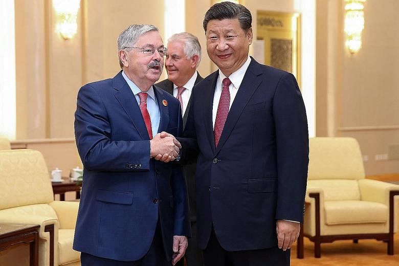 US Ambassador to China Terry Branstad meeting Chinese President Xi Jinping at the Great Hall of the People, in Beijing, in 2017. Mr Branstad was denied permission to visit one of the centres opened by the US State Department on college campuses in Ch