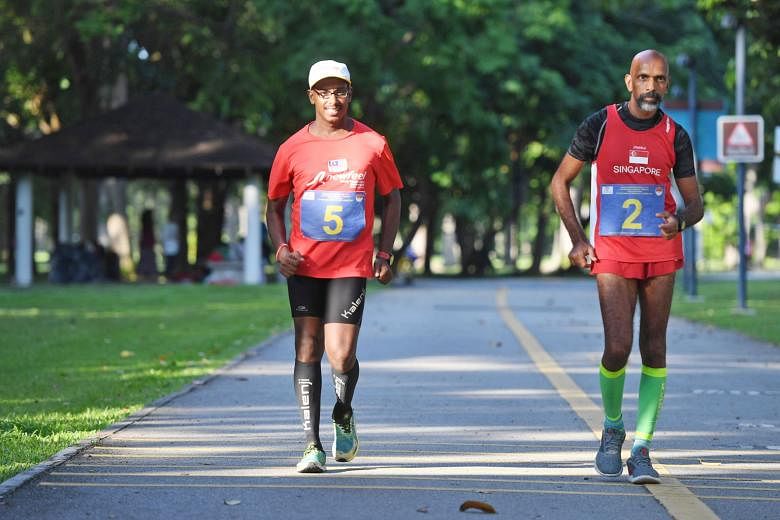 Veteran walkers R. Subramaniam and G. Suresh Kumar (with cap) on the last 40km of their 200km bicentennial walk yesterday. Eight walkers started the attempt last Saturday but six dropped out along the way.