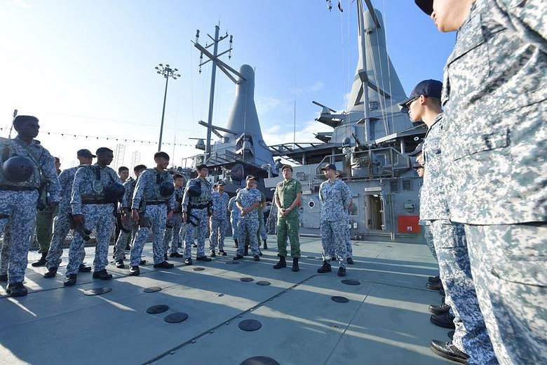 Above: Chief of Defence Force Melvyn Ong addressing the crew of the Republic of Singapore Navy's littoral mission vessel RSS Justice and members of the Accompanying Sea Security Team at Tuas Naval Base yesterday. 