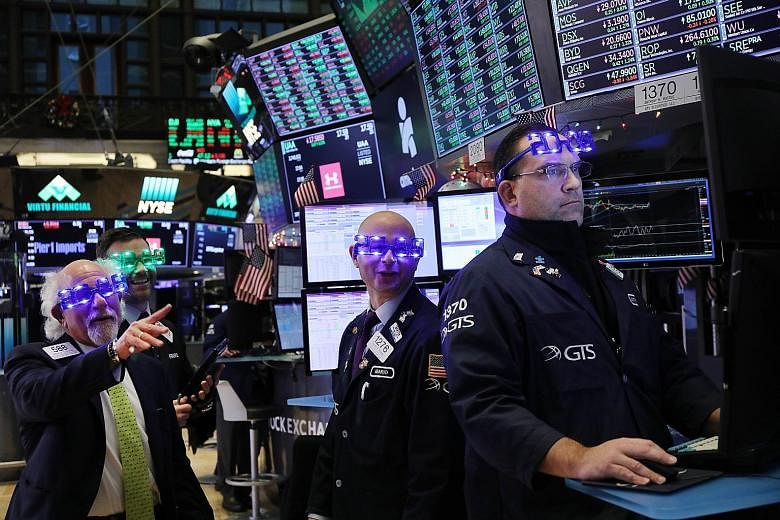 Traders at the New York Stock Exchange on the last day of the trading year on Monday. Despite the day's boost, the Dow Jones Industrial Average finished last year with a loss of 5.6 per cent compared with the end of 2017, the S&P 500 with a drop of 6