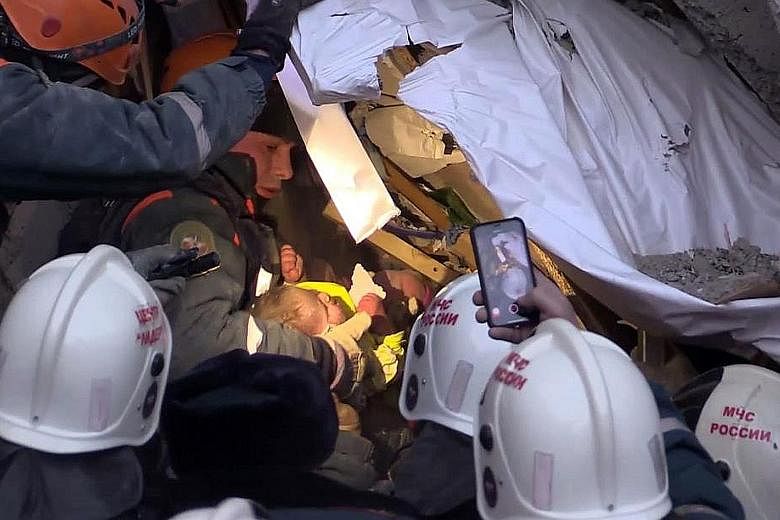 Emergency officers rescuing a baby who was found alive yesterday after being trapped under the rubble of a Russian apartment block for 35 hours. The block partially collapsed in an explosion. The 11-month-old has been diagnosed with serious freezer b