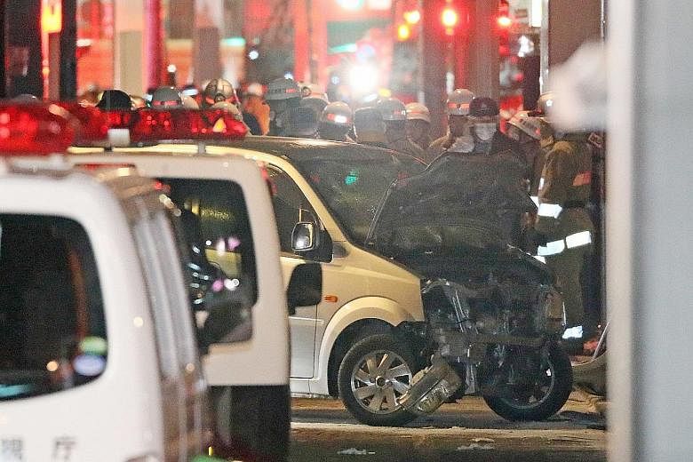 Police inspecting the rented car that Kazuhiro Kusakabe drove into a group of pedestrians in Harajuku's Takeshita Street. The car came to a stop when Kusakabe crashed into a building. It bore an Osaka licence plate and carried a tank with 20 litres o