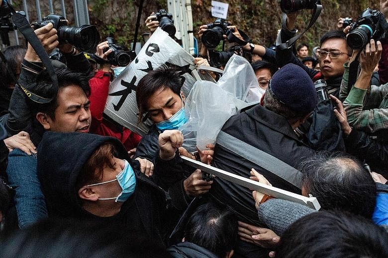 Protesters and guards clashing in Hong Kong during yesterday's pro-democracy rally. Police said some 3,200 people attended the march at its peak, while organisers gave a higher figure of 5,500 people.