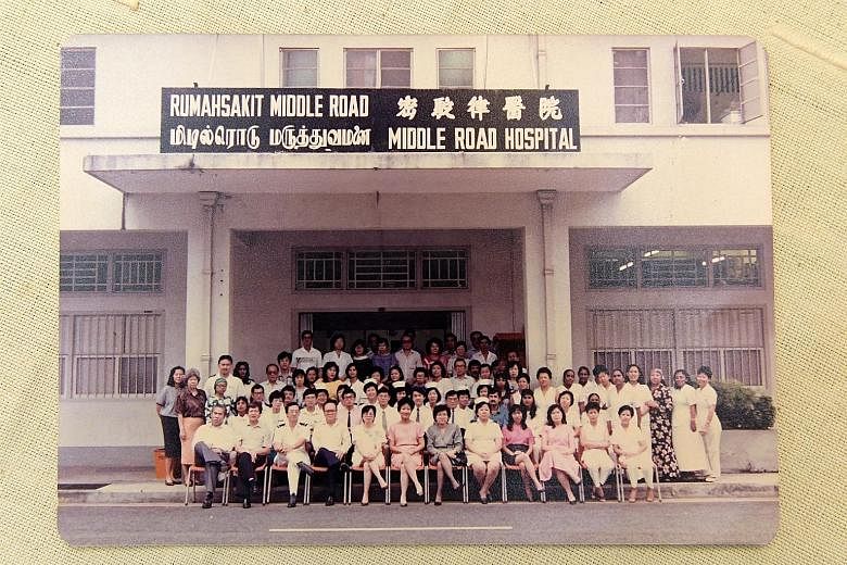 Above: Mrs Verghese (top row, fourth from left, in purple) with her Middle Road Hospital colleagues. The hospital was designated to handle Aids cases at the time. Above, left: Mrs Verghese outside the venue for an international Aids conference in Dur