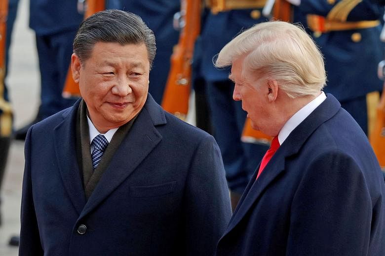US President Donald Trump with Chinese President Xi Jinping during a visit to Beijing in 2017. In his congratulatory message to Mr Xi yesterday, Mr Trump said it was his priority to promote cooperative and constructive US-China relations. The two lea