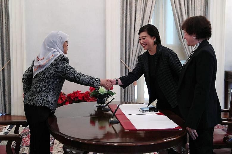 President Halimah Yacob shaking hands with Ms Chua Sock Koong, who took her oath before Judge of Appeal Judith Prakash at the Istana yesterday. Ms Chua is an alternate member of the Council of Presidential Advisers.