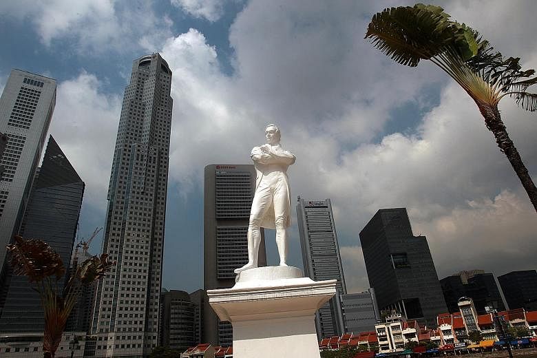 The white, polymarble statue of Sir Stamford Raffles by the Singapore River (left) has been partially painted over to blend in with the OCBC Centre building across the water (below left).