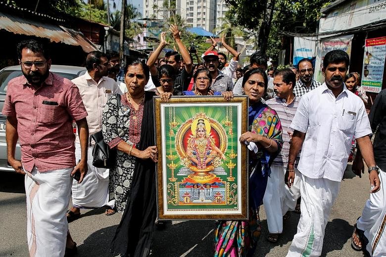 Protesters carrying a portrait of the deity Lord Ayyappa during a rally yesterday called by various Hindu organisations after the two women entered the Sabarimala temple in Kochi, Kerala. Women between the ages of 10 and 50 were banned out of traditi
