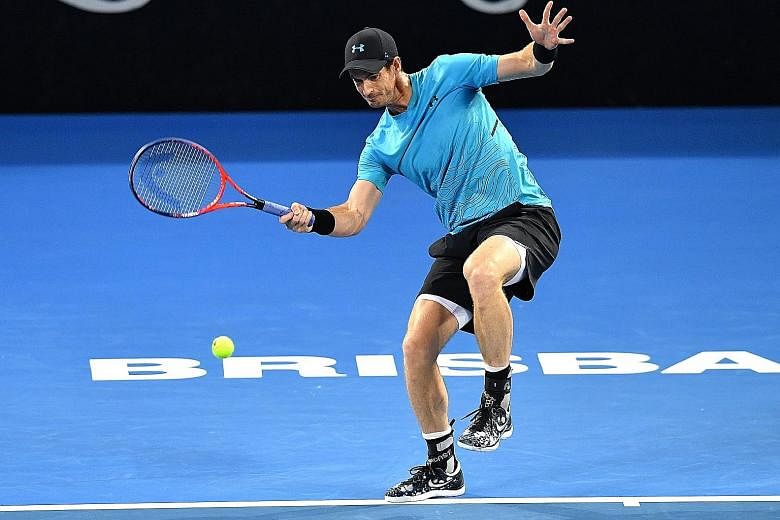 Andy Murray attempting to hit a return during his second-round match against Daniil Medvedev at the Queensland Tennis Centre in Brisbane yesterday. The Russian won in straight sets.