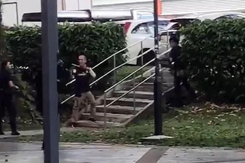 A video of the incident shows a man carrying a long blade facing off with some police officers.